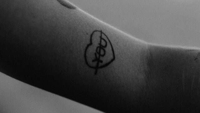 black tattoo on persons arm