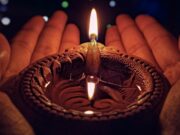 Yandachya Dipavalila – lighted candle on brown round holder