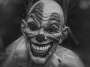 Horror grayscale photography of person wearing clown mask
